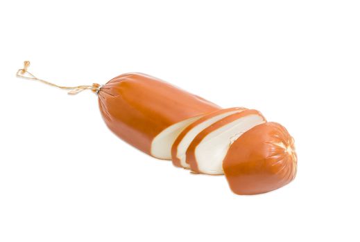 One smoked processed cheese in the form of sausage partly sliced on a light background 
