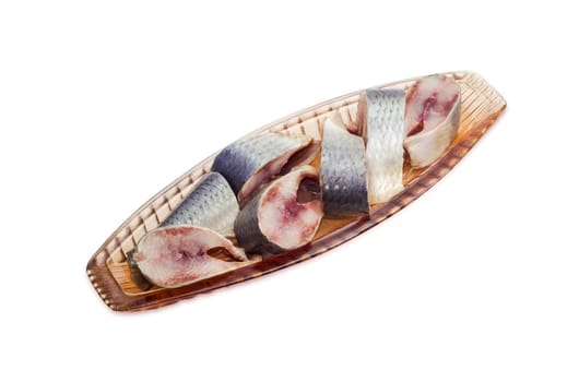 Pickled atlantic herring in pink glass herring-dish on a light background

