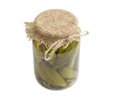 Homemade pickled cucumbers with spices in glass jar on a light background
