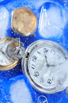 Few watches closeup under frozen water background with ice