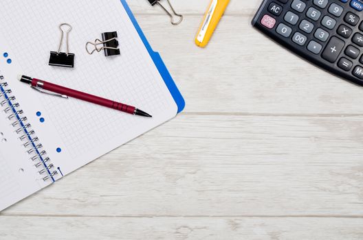 Business desk in office top view. Table with calculator, notepad, and office supplies. Copy space website banner concept