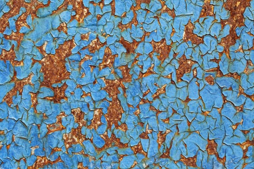 Close-up of peeling paint and rust on a wall