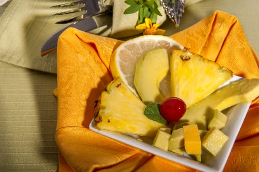 pineapple and ripe advocated on a green place mat