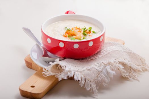 A bowl of creamy cauliflower soup with shrimps