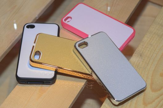 plastic mobile phone cases on a wood background