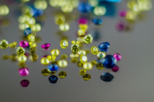 Multi coloured crystals  on white with shallow depth of field