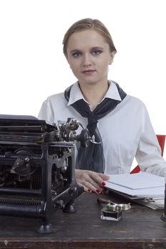 Young girl typist with an old typewriter on a white background