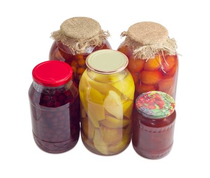 Different canned fruits, jam and compote made from pears, plums, apricots, cherries and grapes in glass jars on a light background
