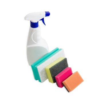 Several synthetic cleaning sponges with layer for more intense scrubbing different colors and sizes and plastic spray bottle of cleaning agent on a light background
