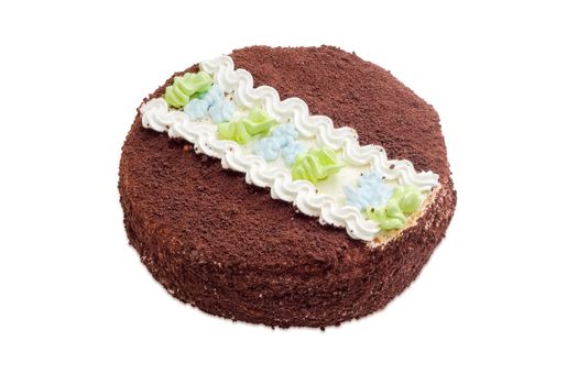 Round sponge cake, dusted with cocoa powder and chocolate chips and decorated with a pattern of butter cream on a light background
