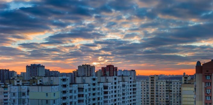 Sunset over the housing estate with modern multi-storey apartment buildings in a big city

