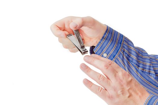 Nail clipper in the compound lever style made of stainless steel in male hands on a light background
