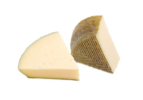 Two pieces of semi-hard Spanish cheese with dark coating manufactured from mixtures of cow and sheep milk on a light background
