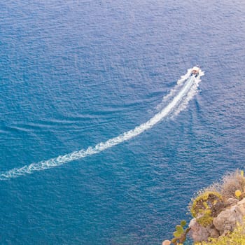 Speedboat cruising over the blue Mediterranean Sea