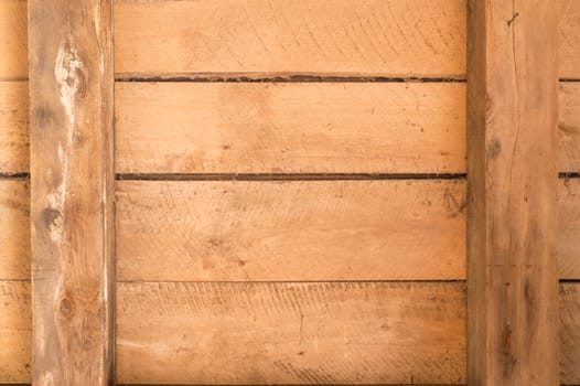 Wooden boards inside an old outbuilding with beams and horizontal arrangement