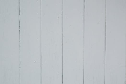 Fresh white painted boards on a boathouse.   Run vertically.