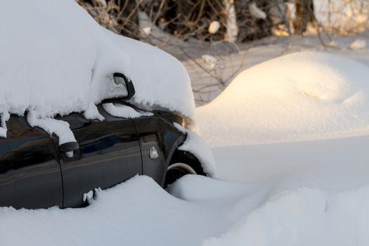 Snow covered car from a heavy winter