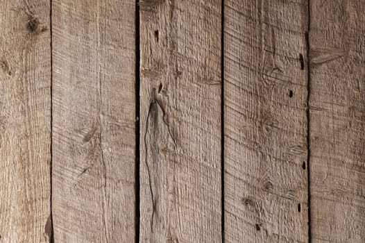 Rough wooden boards inside an old outbuilding with saw marks and vertical arrangement
