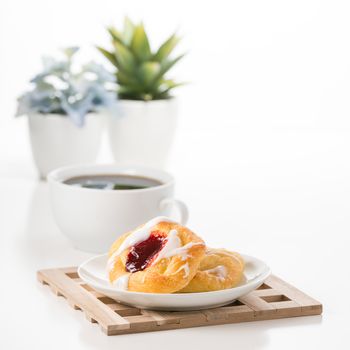 Raspberry danish served with a fresh cup of coffee.