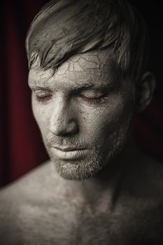 Portrait of Young Men with Skin Covered in Mud.