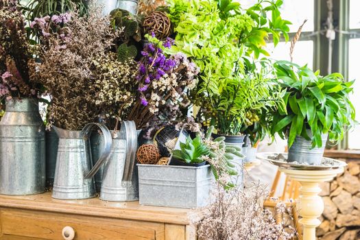 various plant and dry flower in zinc bucket on the table