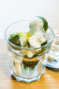 matcha ice cream and fresh milk in glass on wooden table