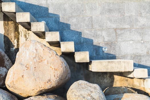 stone and concrete ladder on beach to house