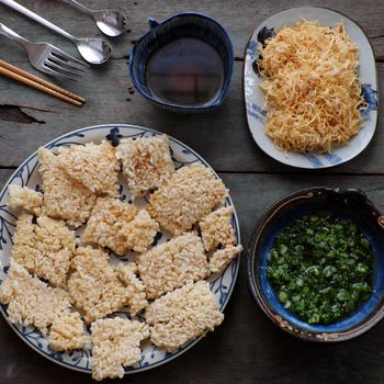 Vietnamese street food, fried dried rice with pork floss, with popular name is com chay cha bong, a tasty snack food, woman hand process at home to ensure food safety