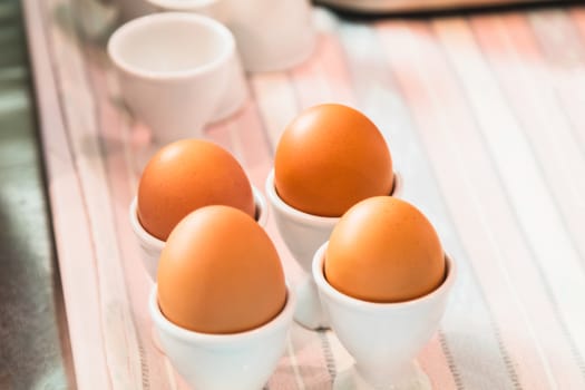 egg cups with natural brown eggs