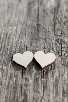 Two small hearts on old wood background