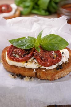 Bruschetta with feta and sun-dried tomatoes slices spiced