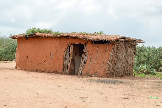 Traditional house of masai in earth and wood in a village of Kenya