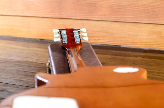 Electric Guitar and case in wood room