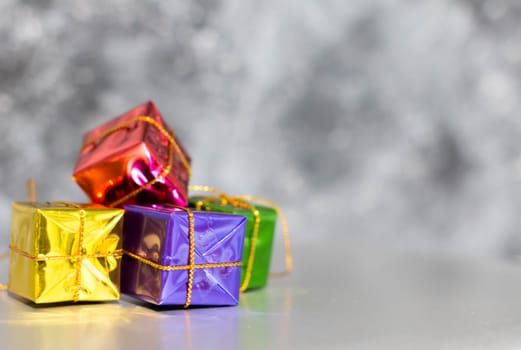 Gift Box And Baubles On Snow With Shiny Background