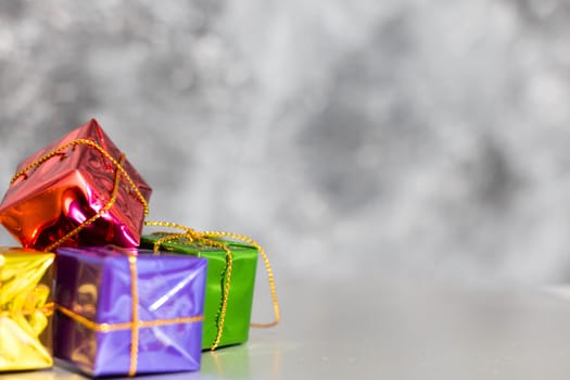 Gift Box And Baubles On Snow With Shiny Background