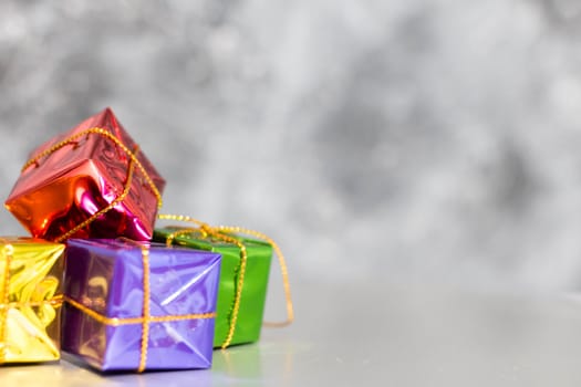 Gift Box And Baubles On Snow With Shiny Background