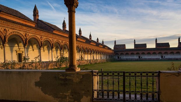 Grand Cloister of the Pavia Carthusian monastery,features columns with precious decorations in terracotta portraying saints, prophets and angels, in white and pink Verona marble,at sunset,Italy.