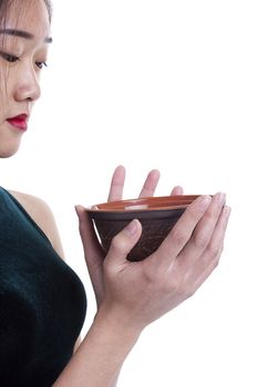 Clay plate in the hands of a young girl