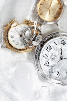Few watches closeup under frozen water background with ice