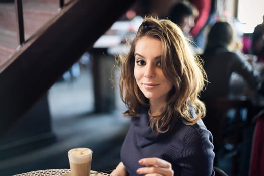Portrait of beautiful girl in Cafe in the city
