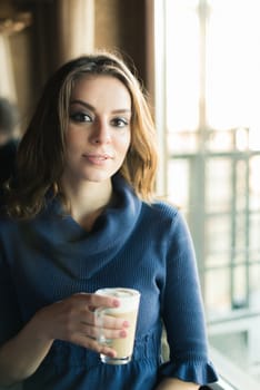 Portrait of beautiful girl in Cafe in the city