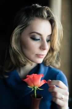 Portrait of a beautiful girl with a rose