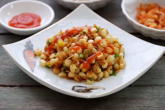 Vietnamese street food, corn fried dried shrimp, is popular snack food make from corn fry with shrimp, butter, scallions, eat with chilli sauce 