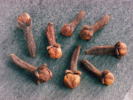 Cloves spice on gray slate background. Extreme close up.