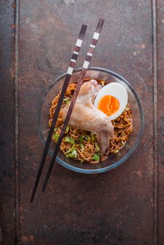 Soup Ramen noodle with chicken wing on the old metal vertical