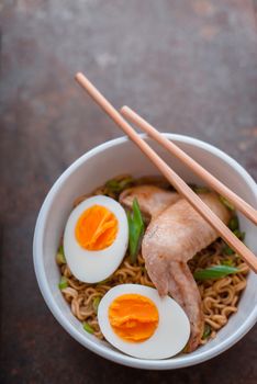 Soup Ramen noodle with chicken wing and bamboo sticks vertical