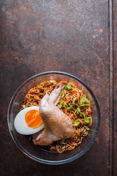 Soup Ramen noodle with chicken wing on the old table vertical