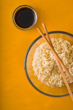 Soup Ramen noodles in bowl and soy sause vertical