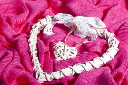 A bamboo heart over a fuchsia fabric