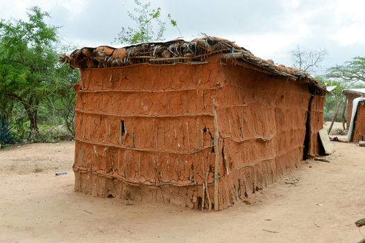 Traditional house of masai in earth and wood in a village of Kenya